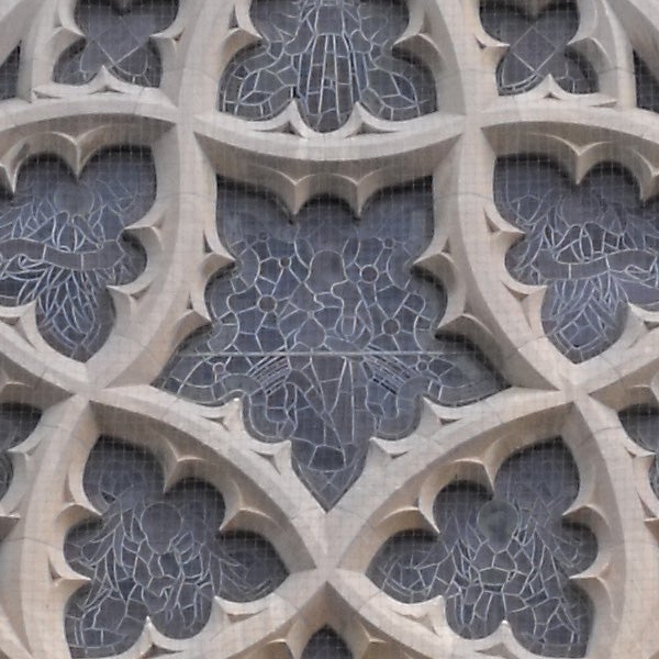 Close-up of a Gothic stone window tracery with crackle texture.