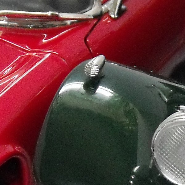 Close-up of a vintage red and green toy car.