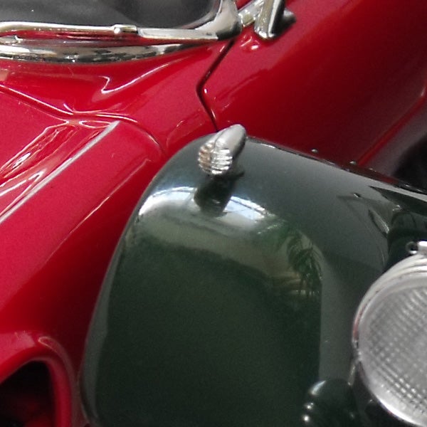 Close-up of a red and green model car hood and headlights