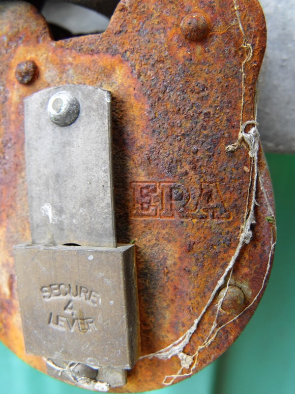 Close-up of a rusty padlock with the text 