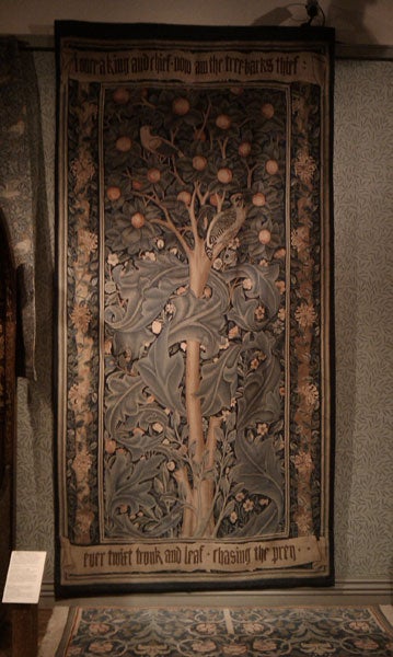 Intricately carved wooden artwork with tree design and text.