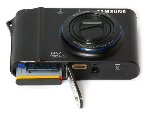 Samsung NV100HD camera with open battery compartment.