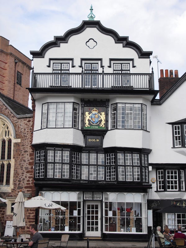 Traditional black and white timber-framed building with crest.