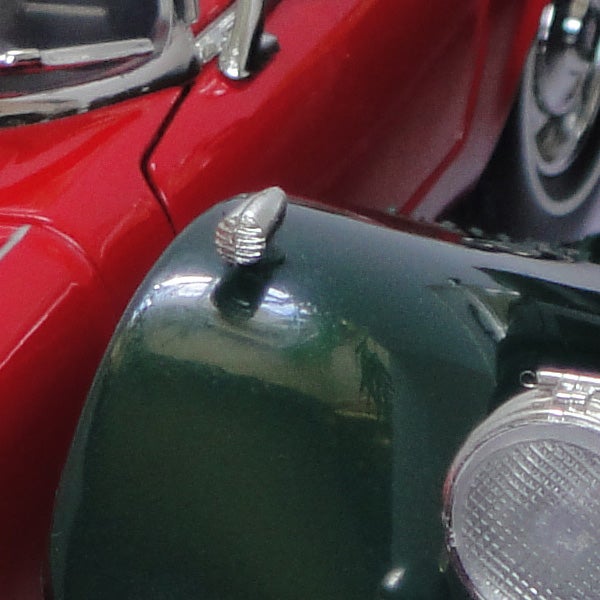 Close-up of classic red and green cars captured with high detail.