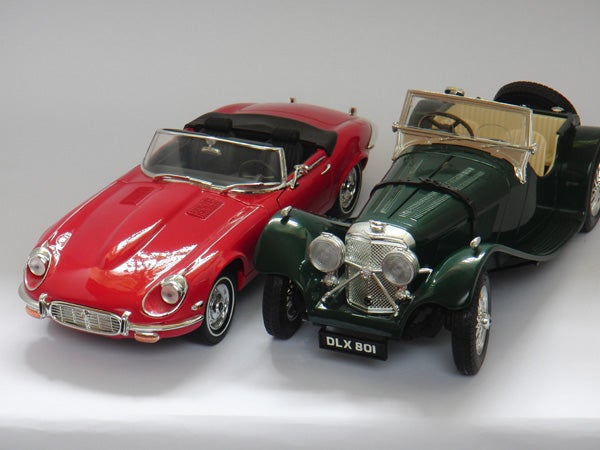 Two classic model cars on a white background