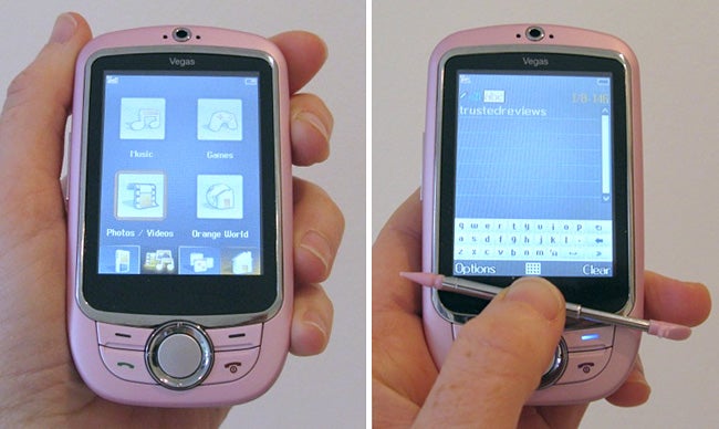 Hands holding an Orange Vegas phone displaying menu and keyboard