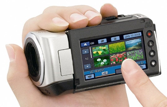 Person holding Sony Handycam HDR-CX105E camcorder.