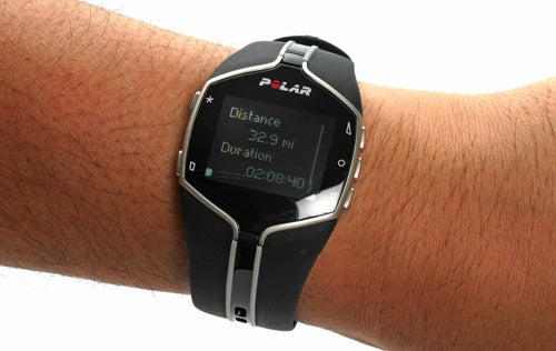 Polar FT80 fitness watch displaying distance and duration on wrist.