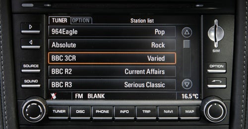 Porsche Cayman's infotainment system displaying radio stations.Porsche Cayman 2.9 PDK infotainment system display.