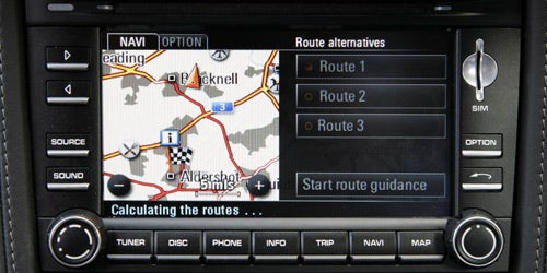 Porsche Cayman navigation system displaying route options.Porsche Cayman navigation system display showing map and controls.