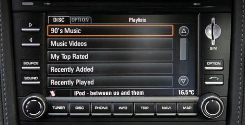 Porsche Cayman's infotainment system displaying music playlist options.
