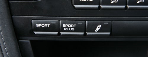 Porsche Cayman 2.9 PDK sport mode buttons close-up.