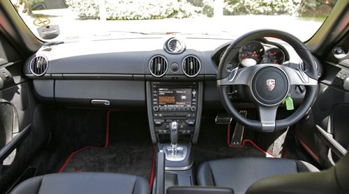 Interior view of Porsche Cayman 2.9 PDK with steering wheel and dashboard
