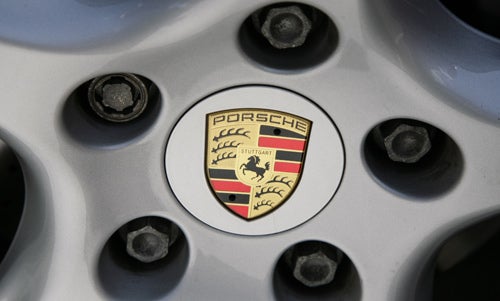 Close-up of Porsche emblem on wheel rim.