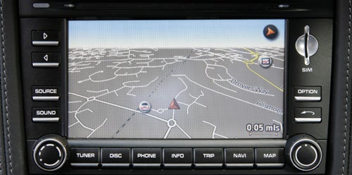 Porsche Cayman navigation system display with map and controls.