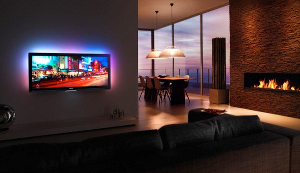 Philips Cinema 21:9 LCD TV in a modern living room setting.