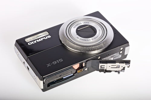 Olympus X-915 camera with open memory card slot.
