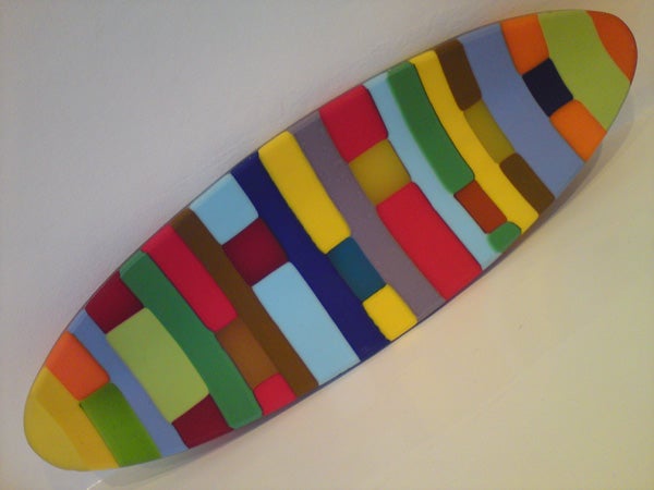 Colorful surfboard-shaped object with abstract design