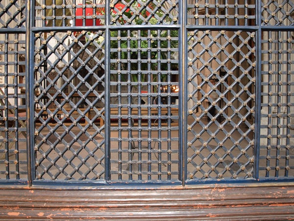 Metal security gate in front of a shop entrance