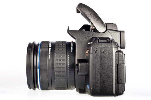 Olympus E-620 DSLR camera with lens and flash up.