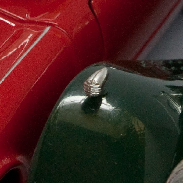 Close-up of a screw on a camera body with background.
