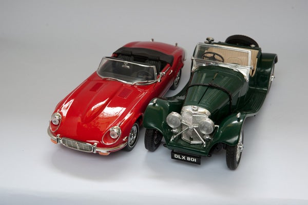 Red and green model cars on a white background