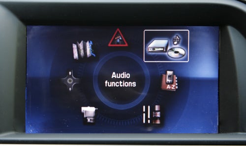 Citroen C5 Tourer's infotainment system displaying audio functions.Citroen C5 Tourer's infotainment system display showing clock and music track.