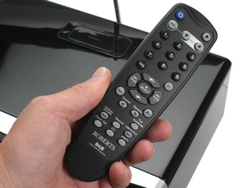 Hand holding a Roberts Sound MP-53 remote control.