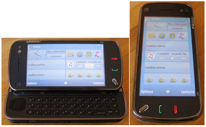 Nokia N97 smartphone with keyboard extended and screen close-up.