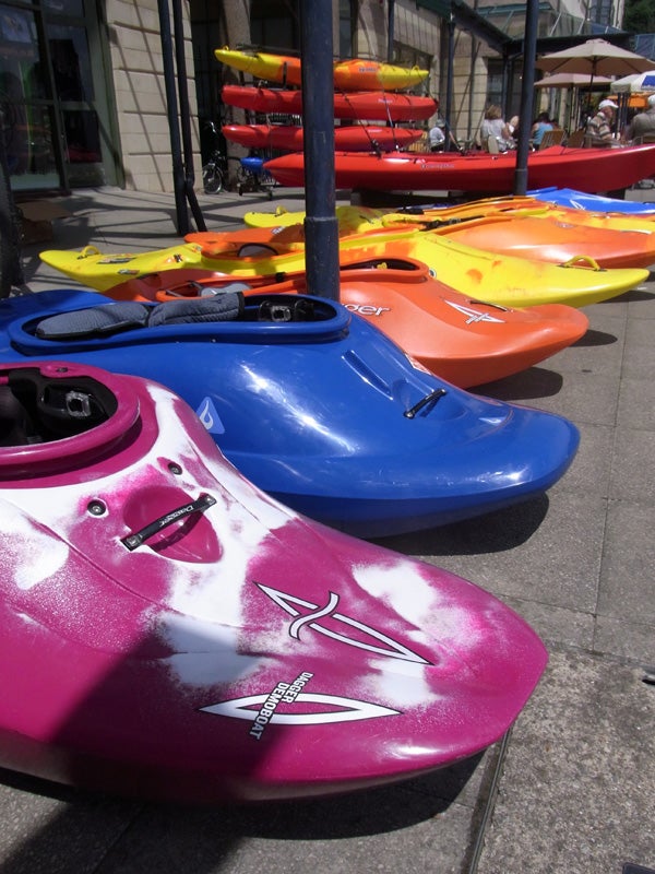 Colorful kayaks lined up on a sunny day.