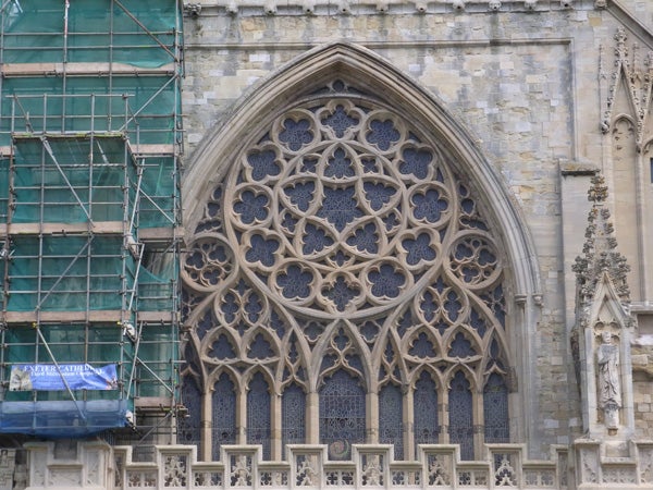 Detailed Gothic window architecture of a historical building.