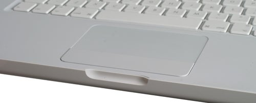Close-up of Apple MacBook's white keyboard and trackpad.
