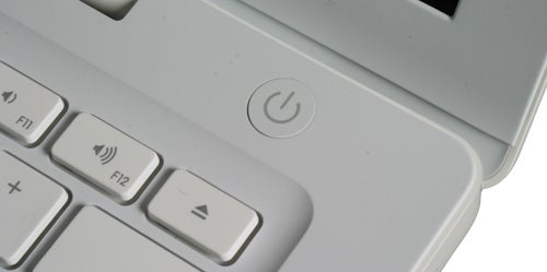 Close-up of white MacBook keyboard and power button.