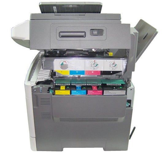 Open multifunction printer showing color toner cartridges.