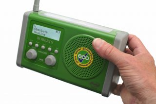 Hand holding a green Roberts solarDAB Radio.