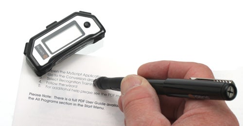 Hand holding e-Pens Mobile Notes Digital Pen over paper.
