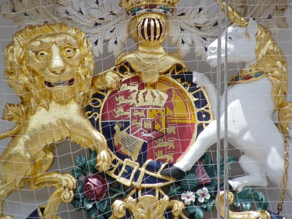 Golden lion sculpture with intricate crest detail.