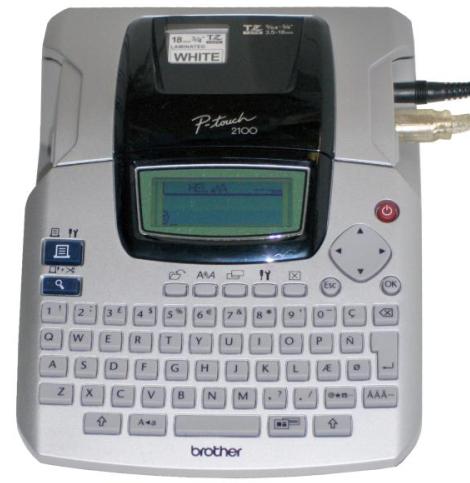 Brother P-Touch 2100 label printer on a white surface.