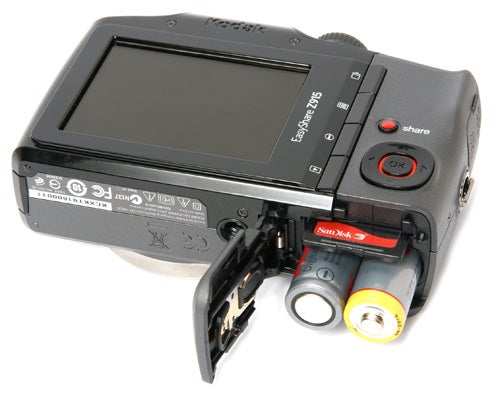 Kodak EasyShare Z915 camera with open battery compartment.
