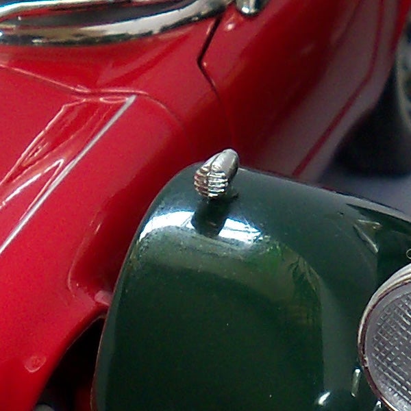 Close-up of a vintage car's red and green bodywork.