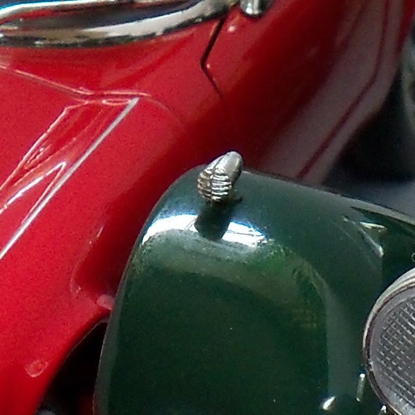 Close-up of a red and green vintage toy car
