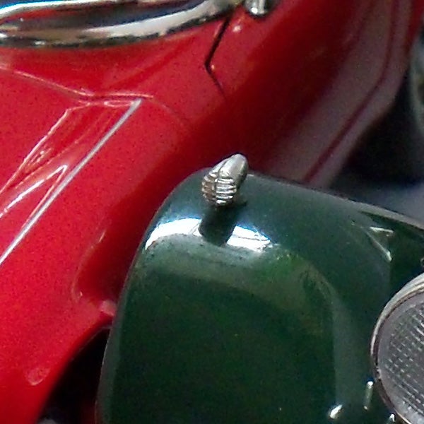 Close-up of a vintage green and red toy car.