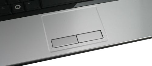 Dell Studio 1555 laptop touchpad and buttons close-up.