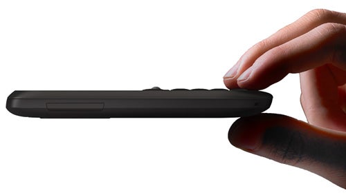 Hand holding a slim HTC Snap smartphone against a white background.