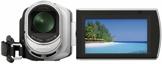 Sony Handycam DCR-SX30E camcorder with open LCD screen displaying beach.