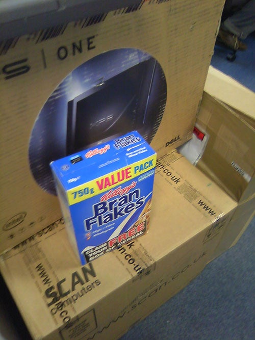 Cereal box on top of computer equipment cardboard boxes
