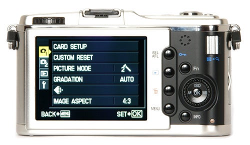Olympus Pen E-P1 camera with menu screen displayed.