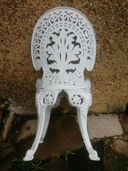 White ornate garden chair on a patio
