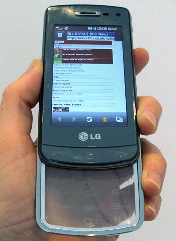 Hand holding LG Crystal GD900 with transparent keypad.