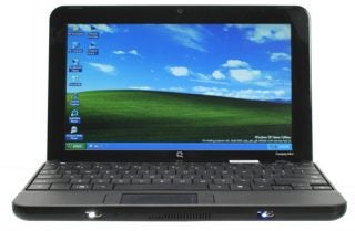 HP Compaq Mini 110c netbook with Windows XP on screen.
